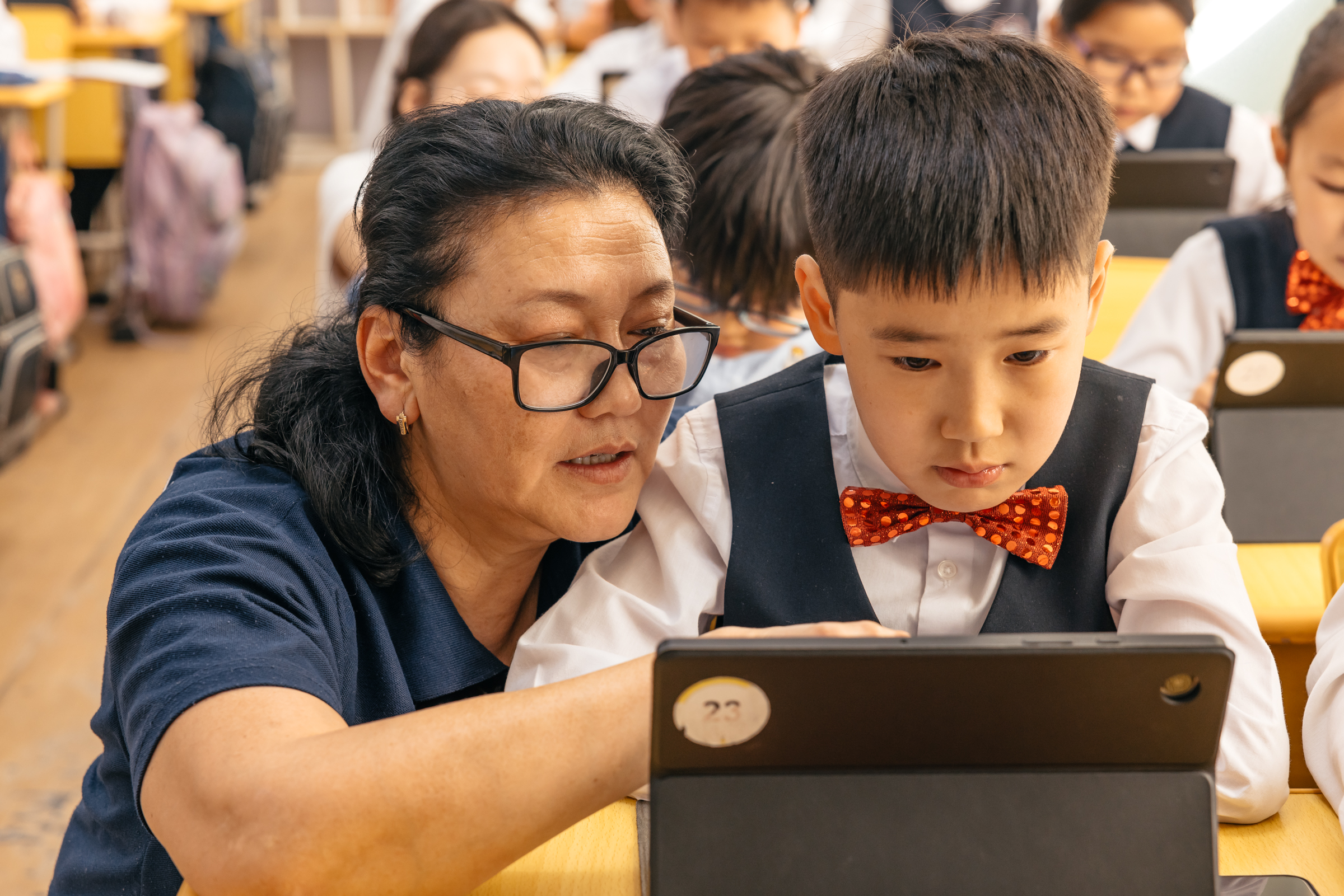 Teacher guiding student in using EdTech platform - Mongolia